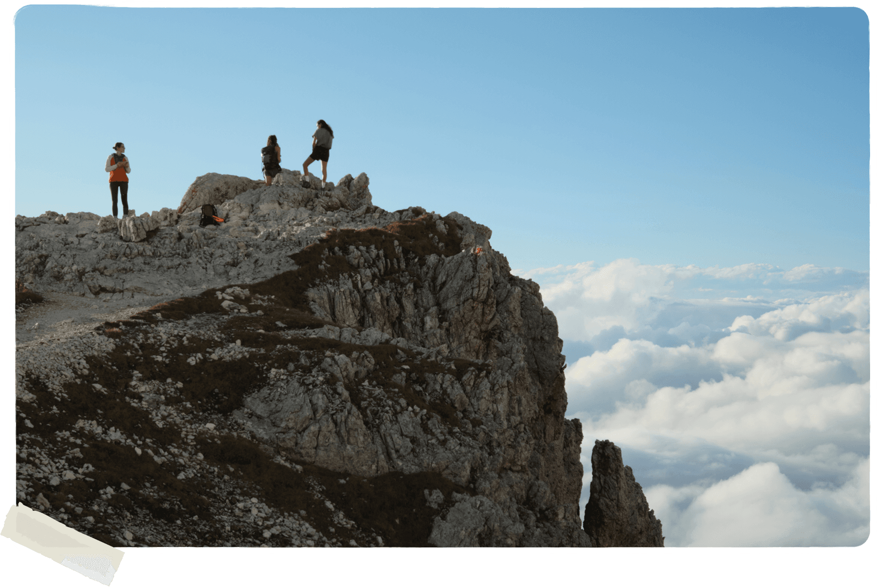 hikers standing on top of dolomite mountain ridge